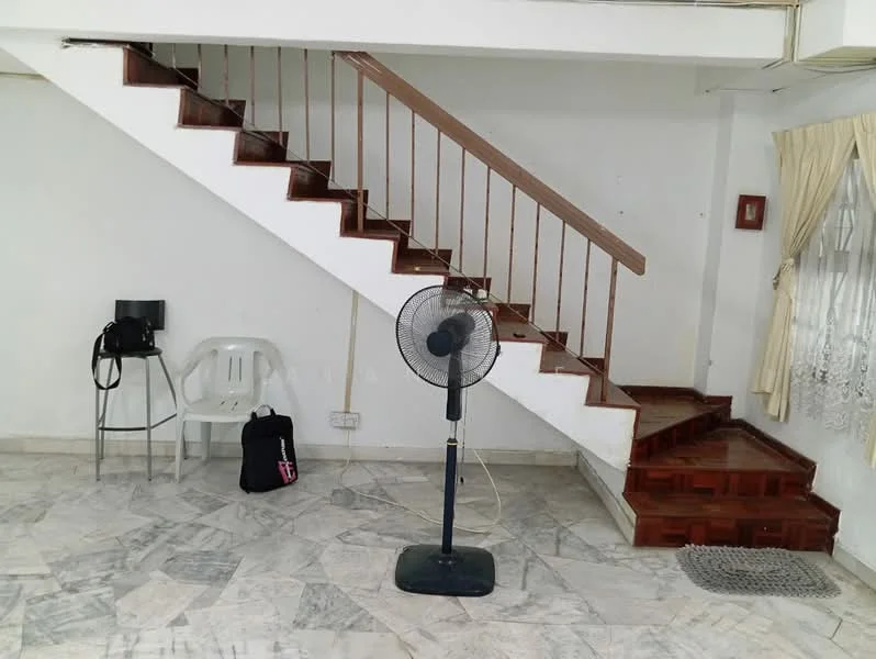 Room features: marble flooring, white painted walls, wooden staircase, ceiling fan, window with sheer curtains, plastic chair, metal stool, backpack, doormat.