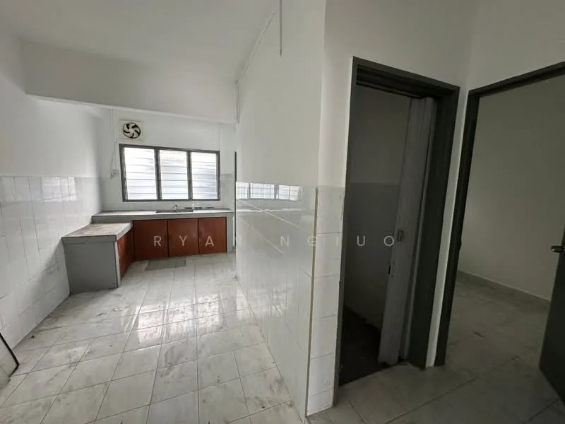 Kitchen features: white tiled walls, grey tiled flooring, wood cabinetry in brown, single-bowl stainless-steel sink, wall-mounted exhaust fan, window with horizontal slats, countertop space, open layout. Room features: doorway leading to another room, white painted walls, grey tiled flooring.