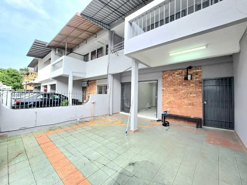 Exterior type: linked terrace house; features: exposed brick facade, grey painted walls, flat roof, paved flooring, fenced perimeter, car parking space, covered porch area, outdoor bench, security grilles on doors; style: modern.