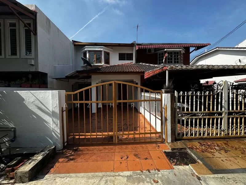 Exterior type: semi-detached house; features: golden metal gate, tiled driveway, white painted facade, red tiled roof, overhanging eaves, front porch area, surrounding fencing, mature trees, paved walkway, outdoor lighting fixtures; style: traditional.