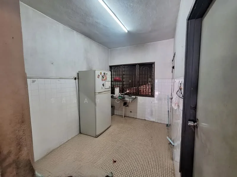 Kitchen features: white painted walls, tile flooring, single-door fridge, stainless-steel sink, wall-mounted cabinets, countertop, window with metal grille, light fixture on ceiling.
