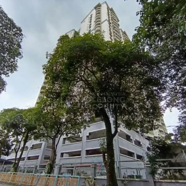 Exterior type: high-rise condominium; features: concrete facade, green landscaping with trees, multi-storey car park, balconies on upper floors, surrounded by mature greenery, elevated building structure; style: modern.