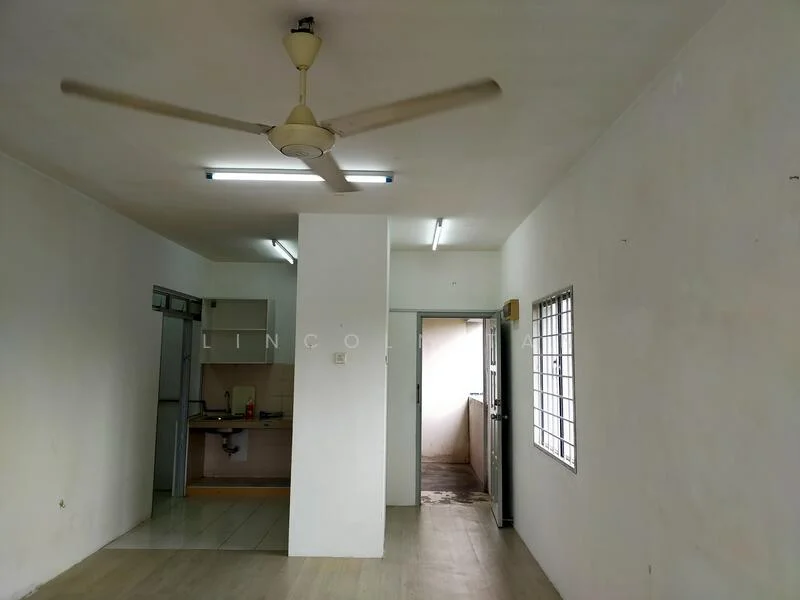 Room features: white painted walls, vinyl plank flooring, ceiling fan, fluorescent lighting, kitchen area visible, door leading outside, window with metal grille.