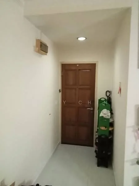 Room features: white painted walls, tile flooring, wooden door with panels, wall-mounted air conditioning unit, ceiling light fixture, shoe rack, coat hooks.
