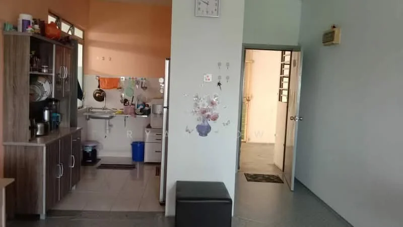 Room features: light green painted walls, grey tiled flooring, wooden cabinetry, stainless-steel sink, wall-mounted mirror, doorway leading to another room, clock on the wall, open layout, kitchen area visible, blue trash bin, decorative wall stickers; style: modern.