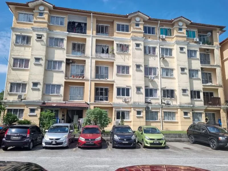 Exterior type: low-rise apartment block; features: yellow painted facade, 3-storey building, balconies with railings, window air conditioning units, visible parking lot, landscaped greenery in front, multiple parked cars, entrance door visible, roof overhang, security grills on windows; style: modern.