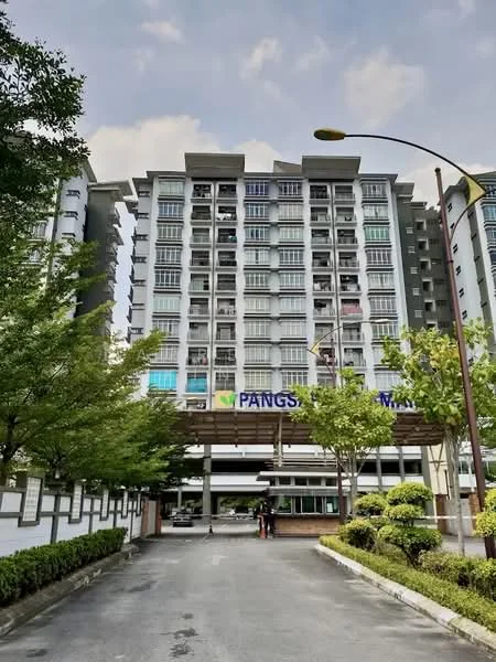 Exterior type: mid-rise condominium; features: grey painted facade, balconies with glass railings, multiple storeys, landscaped garden with shrubs, paved driveway, entrance canopy, street lighting, visible signage, mature trees lining the driveway; style: modern.