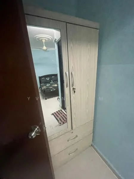 Room features: light blue painted walls, ceiling fan, wooden wardrobe with mirror, two drawers in wardrobe, carpeted flooring, striped area rug.