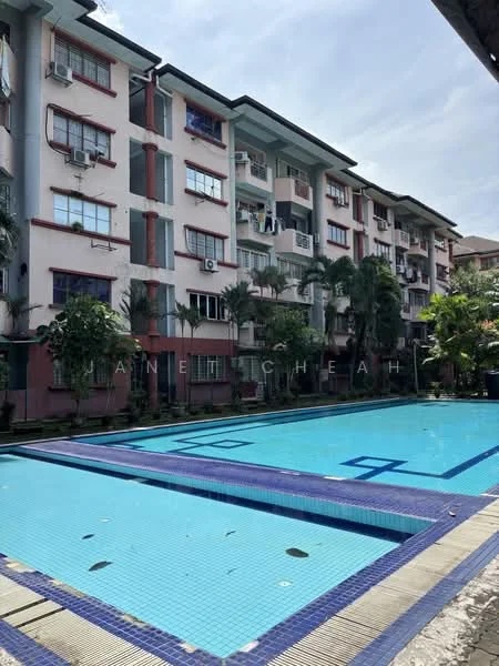 Exterior type: low-rise apartment block; features: swimming pool, pool deck, landscaped garden, balconies on upper floors, palm trees, air conditioning units visible, manicured lawn, blue tiled pool, surrounding greenery; style: modern.