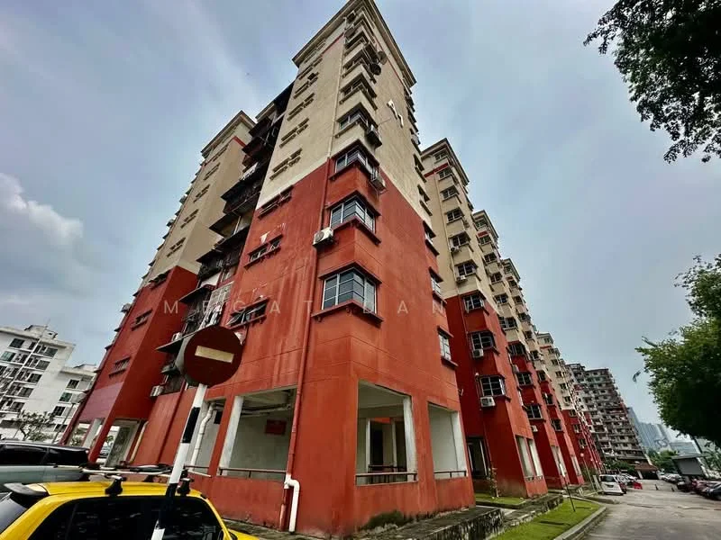 Exterior type: low-rise apartment block; features: red painted facade, white window frames, balconies on upper floors, multiple air conditioning units visible, surrounded by greenery, street view with parked cars; style: modern.