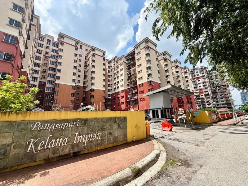 Exterior type: low-rise apartment block; features: multi-storey building, red and cream painted facade, guard house at entrance, landscaped entrance with signage, surrounded by greenery, parking area visible; style: modern.