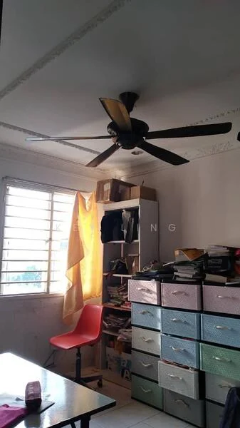 Room features: 5-blade ceiling fan, window with horizontal slats, yellow curtain, white painted walls, built-in shelving unit, colorful storage drawers, table, various books and items on shelves.