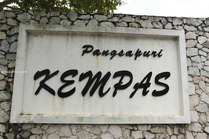 Exterior features: stone wall, signage with name 'KEMPAS', white painted surface, natural stone cladding, greenery above the sign; style: modern.