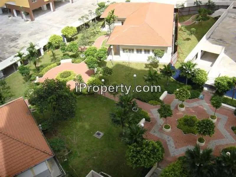 Exterior type: low-rise apartment block; features: landscaped garden, manicured lawn, paved walkways, mature trees, tropical landscaping, multiple garden paths, outdoor seating areas, swimming pool area, terracotta roof, single-storey buildings; style: tropical-modern.
