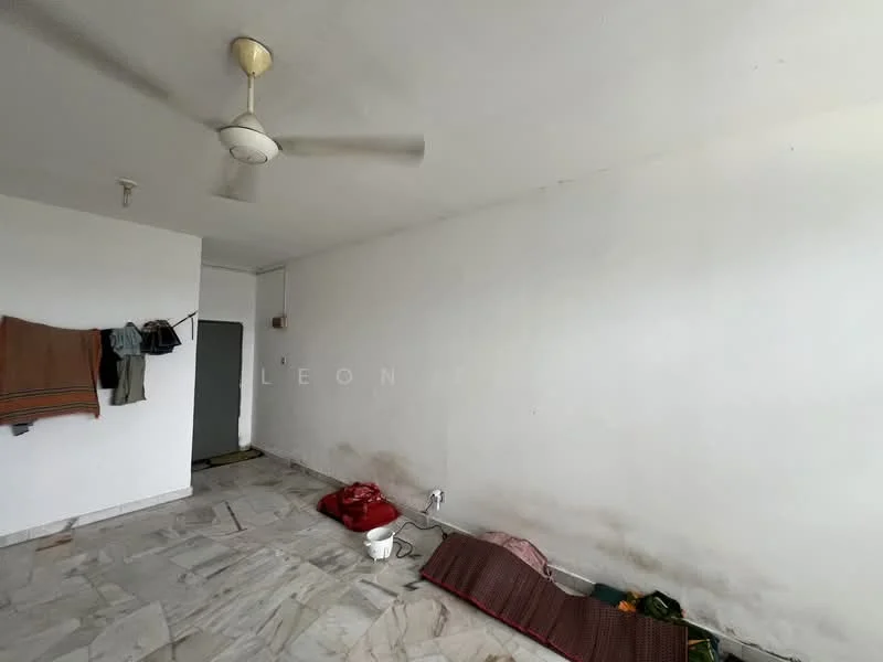Room features: white painted walls, marble flooring, ceiling fan, hanging clothes on wall, doorway, visible electrical outlet, floor with some stains, blank wall space.