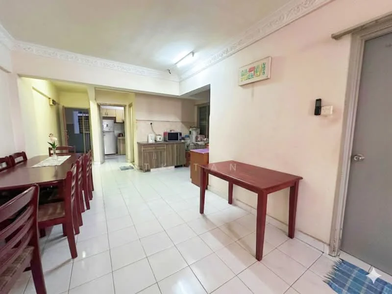Dining features: white painted walls, white tiled flooring, dining table with four chairs, wooden side table, recessed ceiling lights, doorway leading to kitchen, door leading to hallway, decorative wall trim. Kitchen features: kitchen cabinetry, countertop, refrigerator visible in background, microwave visible in background, cooking appliances visible in background.