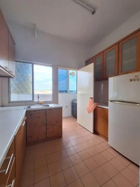 Kitchen features: wood cabinetry, white countertop, single-bowl stainless-steel sink, chrome faucet, built-in fridge, oven, tile flooring in beige, window with sheer curtains, natural light from window, kitchen island, open layout, wall-mounted cabinets with glass fronts; style: modern; view: city.