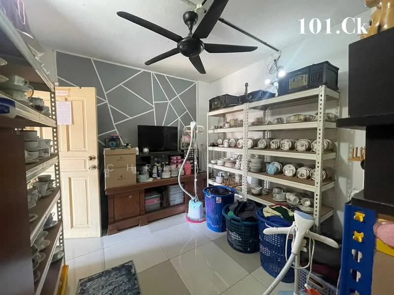 Laundry features: white tiled flooring, grey accent wall with geometric pattern, 5-blade ceiling fan, wooden cabinet, black TV on wooden console, metal shelving units, various dishware on shelves, vacuum cleaner, blue laundry baskets, cleaning supplies, door leading to outside, decorative rug; style: modern.