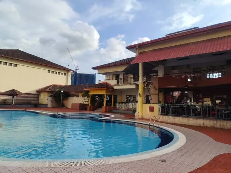 Exterior type: clubhouse; features: swimming pool with curved edge, pool deck with loungers, two-storey clubhouse, red tiled roof, yellow painted columns, outdoor dining area, landscaped garden area, surrounding brick pavement, visible construction cranes in background; style: modern.