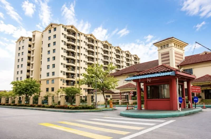 Exterior type: mid-rise condominium; features: cream painted facade, recessed balconies, flat roof, approximately 6-storey building, manicured landscaping, guard house at entrance, paved driveway, parking spaces visible, surrounded by mature trees; style: modern.