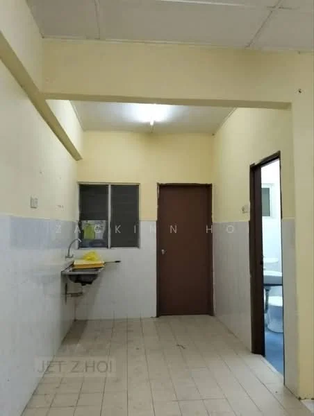Room features: yellow sink, white tiled walls, light yellow painted walls, window with metal grille, brown door, tile flooring, fluorescent ceiling light.