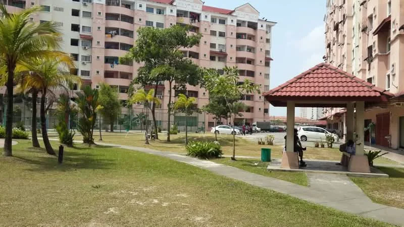 Exterior type: low-rise apartment block; features: landscape garden, manicured lawn, paved walkway, pavilion with red tiled roof, mature trees, surrounding residential buildings, open green space, parking area visible; style: modern.
