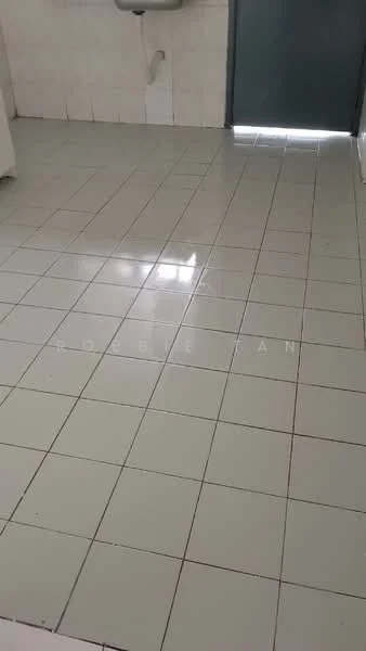 Room features: glossy ceramic tile flooring, white tiled walls, sink mounted on wall, grey door, natural light from door.