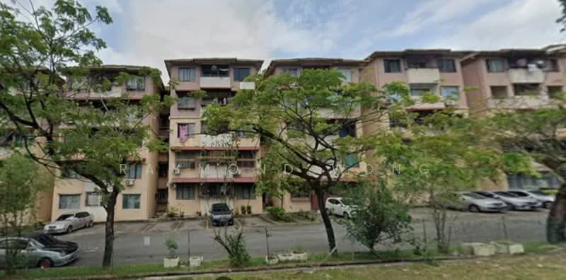 Exterior type: low-rise apartment block; features: pink painted facade, multiple storeys, balconies on each unit, windows with grills, landscaped area with trees, parking area in front, visible cars parked, surrounded by greenery; style: modern.