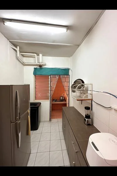 Kitchen features: grey cabinetry, white tiled backsplash, stainless-steel fridge, black trash bin, white countertop, blender, kitchen sink, window with green awning, tile flooring, overhead fluorescent lighting; style: modern.