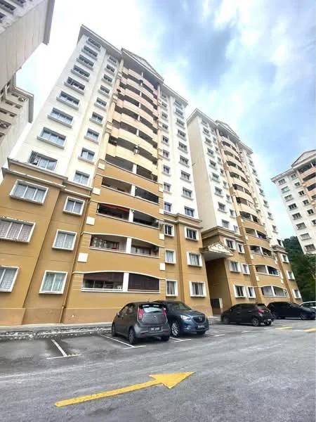 Exterior type: mid-rise condominium; features: cream painted facade, brown accent panels, multiple storeys, balconies on upper floors, windows with grills, parking lot in front, asphalt driveway, surrounded by greenery; style: modern.
