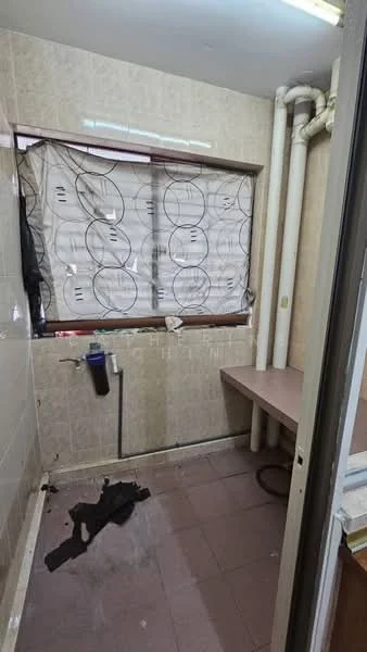 Laundry features: tile flooring, light beige walls, window with sheer curtains, plumbing fixtures, countertop, exposed pipes, dark fabric on floor.