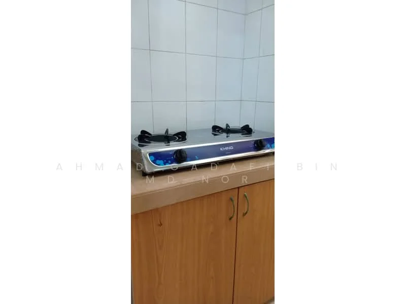 Kitchen features: gas stove with two burners, stainless-steel surface, wooden cabinetry, white tiled walls, countertop, kitchen cabinet doors.