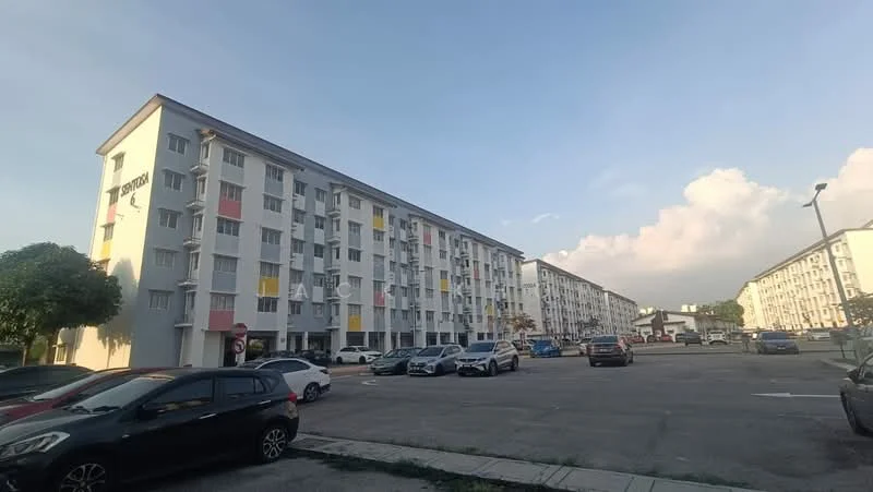 Exterior type: low-rise apartment block; features: white painted facade, red and yellow accent panels, 2-storey building, surrounded by parking lot, landscaped area with trees, multiple windows on each floor, balconies on upper floors; style: modern.