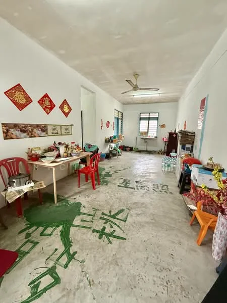 Room features: white painted walls, concrete flooring, ceiling fan, window with blinds, table with chairs, decorative wall art, kitchen appliances, storage cabinets, various items on table, green painted floor design.
