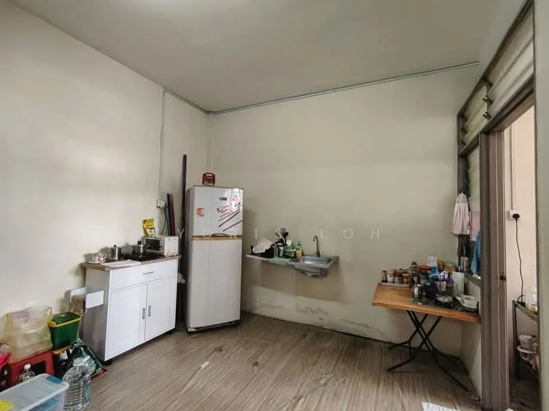 Kitchen features: white cabinetry, stainless-steel fridge, single-bowl sink, chrome faucet, wooden table, plastic containers, water bottles, tile flooring, cream painted walls.