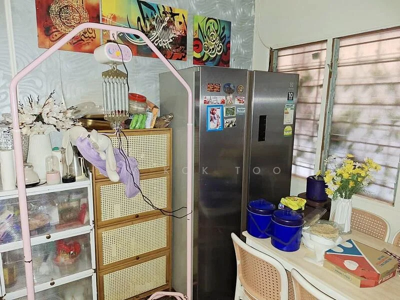 Kitchen features: stainless-steel fridge, wooden dining table, plastic dining chairs, glass-front cabinet, woven storage basket, decorative wall art, flower vase, countertop with food items.
