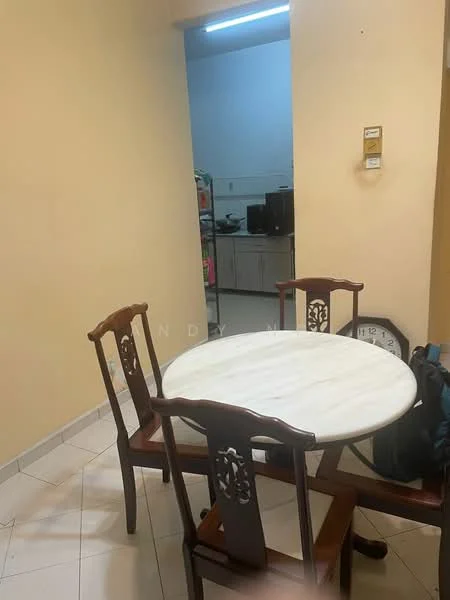 Dining features: round marble dining table, 4 wooden dining chairs, cream painted walls, tile flooring, wall clock, doorway leading to kitchen, kitchen appliances visible in background, light fixture above table.