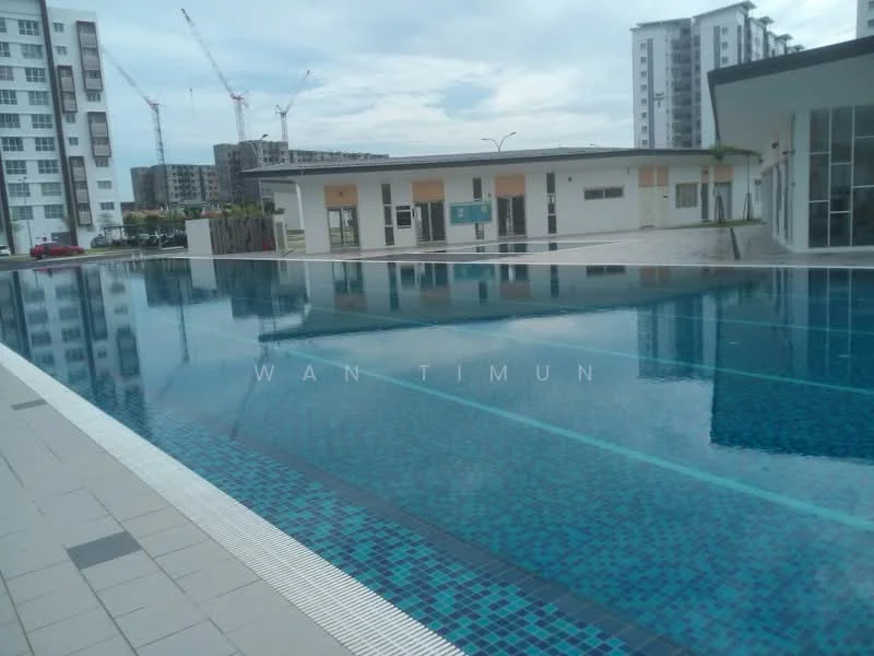 Exterior type: swimming pool deck; features: infinity pool, pool deck with loungers, tiled pool surface, surrounding landscaping, modern clubhouse, glass facade, paved walkway, construction cranes in background; style: modern.