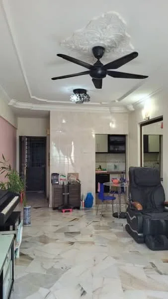 Living features: marble flooring, white painted walls, tray ceiling with decorative moulding, 5-blade ceiling fan in black, wall-mounted light fixtures, piano, black massage chair, small dining table with chairs, open layout to kitchen, decorative plant, kitchen area visible in background; style: modern.