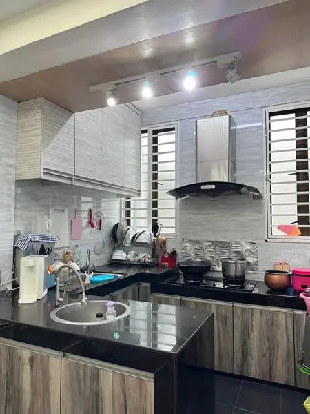 Kitchen features: black granite countertop, stainless-steel single-bowl sink, chrome pull-down faucet, built-in stainless-steel range hood, ceramic tile backsplash, wood cabinetry with grey finish, black laminate base cabinets, stainless-steel cooking pot, stainless-steel frying pan, kitchen utensils, wall-mounted light fixtures, window with horizontal slats; style: modern.