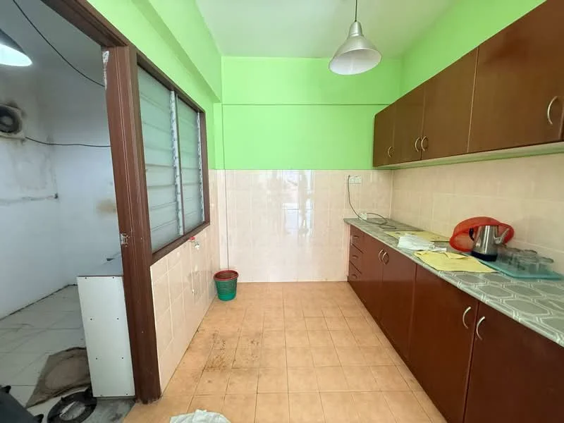 Kitchen features: green painted walls, cream tiled backsplash, brown wooden cabinetry, laminate countertop, stainless-steel kettle, sink, floor tiles, hanging pendant light. Room features: white walls, floor tiles.