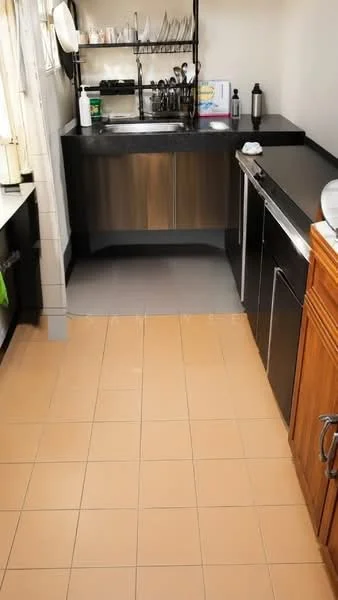 Kitchen features: single-bowl stainless-steel sink, chrome pull-down faucet, black countertop, wood cabinetry, stainless-steel refrigerator, stainless-steel dishwasher, ceramic tile flooring in beige, open shelving, wall-mounted storage rack, window with sheer curtains; style: modern.