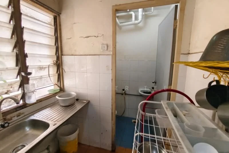 Kitchen features: single-bowl stainless-steel sink, chrome faucet, white tiled walls, blue tiled flooring, wooden cabinet, open shelving, window with slatted blinds, washing area, exposed plumbing.