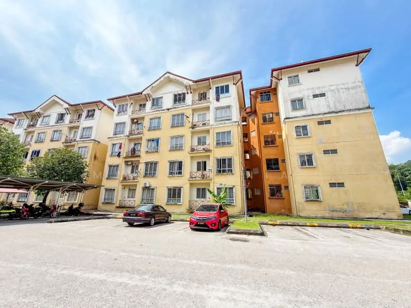 Exterior type: low-rise apartment block; features: yellow painted facade, 3-storey building, balconies on upper floors, car parking area, covered parking spaces, landscaped greenery, multiple windows, adjacent to open space; style: modern.