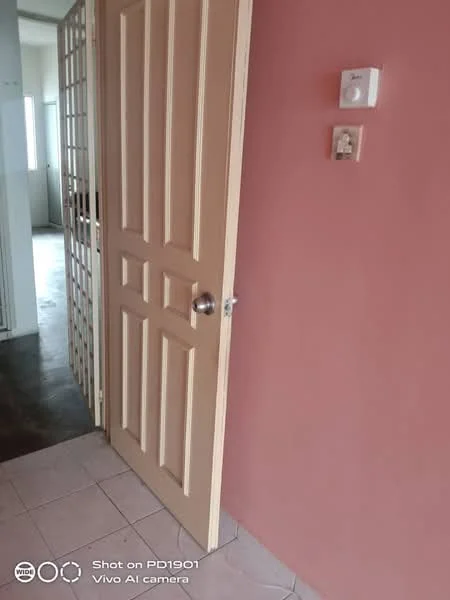 Room features: pink painted walls, light-colored door, door handle, light switch, tile flooring.