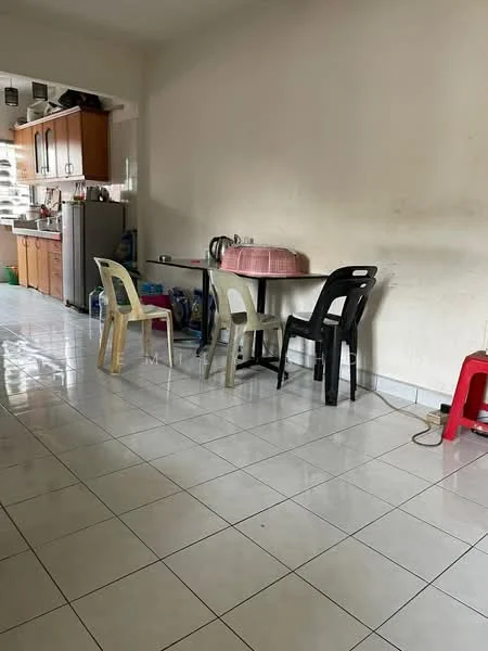 Kitchen features: white painted walls, glossy white tile flooring, wooden cabinetry in light brown, stainless-steel fridge, table with plastic chairs in various colors, kettle on the table, sink with faucet, open shelving above the counter.