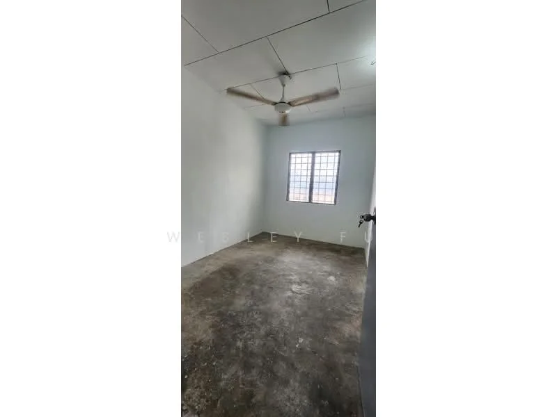 Room features: white painted walls, concrete flooring, ceiling fan, single window, plain ceiling.