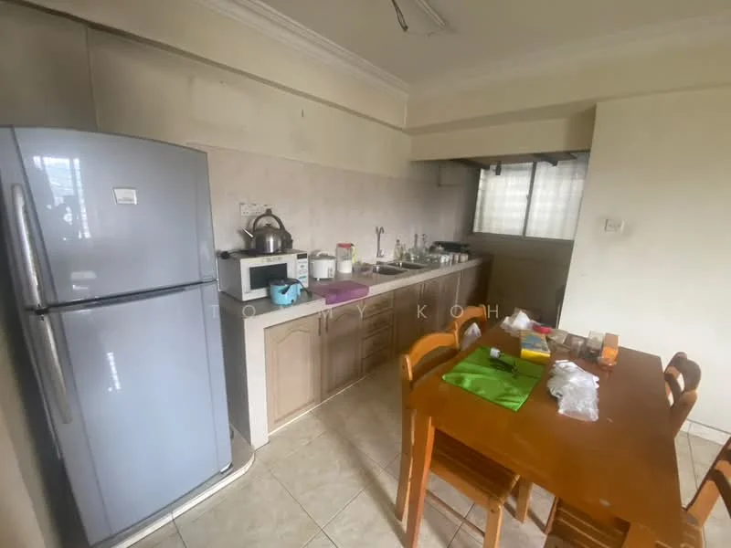 Kitchen features: grey stainless-steel fridge, wood cabinetry, white countertop, ceramic tile backsplash, sink with faucet, stainless-steel kettle, microwave, 4-burner gas hob, dining table with wooden chairs, tile flooring, window with sheer curtains, light fixture on ceiling; style: modern.
