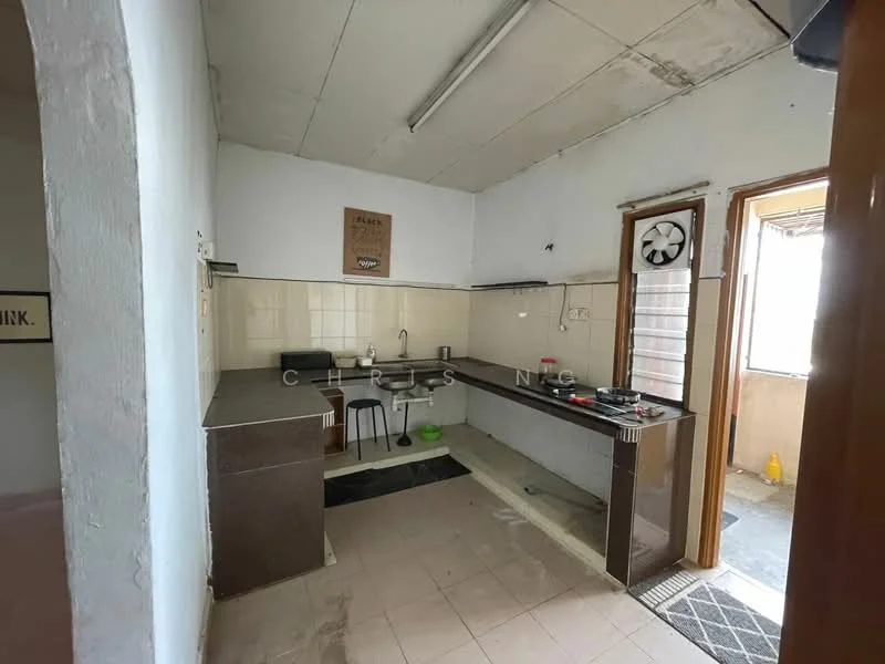 Kitchen features: L-shaped countertop, black granite countertop, white tiled backsplash, single-bowl stainless-steel sink, chrome pull-down faucet, built-in stove, black cabinetry, open shelving, tile flooring, window with view to outside, clock on wall, bar stool, door leading to balcony.