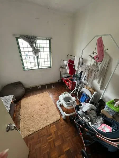 Room features: wooden flooring, white painted walls, green window frames, curtains, area rug, clothes drying rack, baby stroller, storage bins, bean bag chair.
